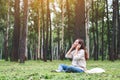 A beautiful woman enjoy listening to music with headphone with feeling happy and relaxed in the park Royalty Free Stock Photo