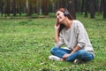 A beautiful woman enjoy listening to music with headphone with feeling happy and relaxed in the park Royalty Free Stock Photo