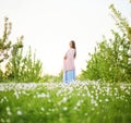 Girl in a flowering garden