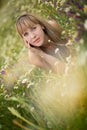 Beautiful woman enjoying daisy field, nice female lying down in meadow of flowers, pretty girl relaxing outdoor, having fun, holdi Royalty Free Stock Photo