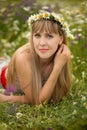 Beautiful woman enjoying daisy field, nice female lying down in meadow of flowers, pretty girl relaxing outdoor, having fun, holdi Royalty Free Stock Photo