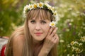 Beautiful woman enjoying daisy field, nice female lying down in meadow of flowers, pretty girl relaxing outdoor, having fun, holdi Royalty Free Stock Photo