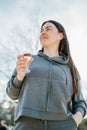 Beautiful woman enjoying glass of rose wine at picnic in park outdoors Royalty Free Stock Photo