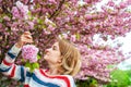 Spring allergy. Beautiful woman enjoying nature blooming tree. Royalty Free Stock Photo