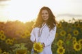 Beautiful Woman Enjoying Nature In The Sunflower Field At Sunset. Traditional Clothes