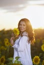 Beautiful woman enjoying nature in the sunflower field at sunset. Traditional clothes. Attractive brunette woman with long and Royalty Free Stock Photo