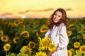 Beautiful woman enjoying nature in the sunflower field at sunset. Traditional clothes. Attractive brunette woman with long and Royalty Free Stock Photo