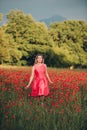 Beautiful woman enjoying nice day in poppy field Royalty Free Stock Photo