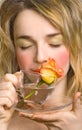 Beautiful woman enjoying the rose and water