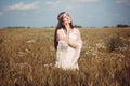 Beautiful woman enjoying the summer sun in a field. Purity and innocence concept Royalty Free Stock Photo