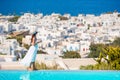 Happy woman relaxing on the edge of pool with amazing view on Mykonos, Greece Royalty Free Stock Photo