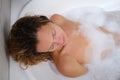 Beautiful woman is enjoying and taking relaxing bubble bath Royalty Free Stock Photo