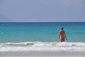 Beautiful woman entering the ocean in Beau vallon beach in Mahe island, Seychelles