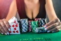 beautiful woman in evening black dress wins poker money in casino. Royalty Free Stock Photo