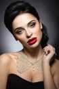 Beautiful woman with evening make-up, red lips and evening hairstyle. Beauty face.
