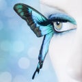 Beautiful woman eye close up with butterfly wings