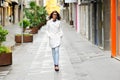 Beautiful woman with eyesglasses walking in urban background