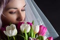 Beautiful woman face with a bouquet of tulips Royalty Free Stock Photo