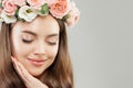 Beautiful Woman Face Closeup. Perfect Young Model Girl with Healthy Skin, Makeup and Flowers. Eyes Closed