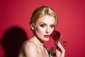 Beautiful woman face and flower. Girl and red rose. Close-up portrait, skin care, make-up. Beautiful fashion girl Royalty Free Stock Photo
