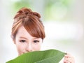 Beautiful woman face portrait with green leaf Royalty Free Stock Photo