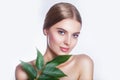 Beautiful woman face portrait with green leaf concept for skin care or organic cosmetics. Studio portrait Royalty Free Stock Photo