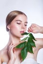 Beautiful woman face portrait with green leaf concept for skin care or organic cosmetics. Studio portrait Royalty Free Stock Photo