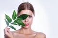 Beautiful woman face portrait with green leaf concept for skin care or organic cosmetics. Studio portrait Royalty Free Stock Photo