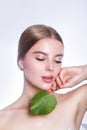 Beautiful woman face portrait with green leaf concept for skin care or organic cosmetics. Studio portrait Royalty Free Stock Photo