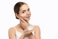 Beautiful Woman Face Skin Care. Portrait Of Attractive Young Female Applying And Holding Cream Cosmetics And Holding Bottle. Royalty Free Stock Photo