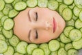 Beautiful woman with facial mask of cucumber slices on face Royalty Free Stock Photo