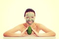Beautiful woman with facial mask holding avocado Royalty Free Stock Photo