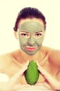 Beautiful woman with facial mask holding avocado Royalty Free Stock Photo