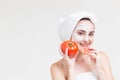 Beautiful woman with facial skincare from Tomato Lycopene and Carotene vitamin for healthy skin