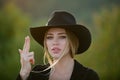 Beautiful woman in fashion hat. Cowgirl in cowboy hat with finger gun. Spring romantic casual woman portrait. Beautiful Royalty Free Stock Photo