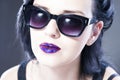 Beautiful woman fashion model portrait in sunglasses with red and blue lips. Creative hairstyle and make up Royalty Free Stock Photo