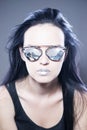 Beautiful woman fashion model portrait in sunglasses with reflections of mountains and metallic silver lips. Creative hairstyle an