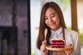 A beautiful woman, female chef baking and eating a piece of red velvet cake in wooden tray Royalty Free Stock Photo