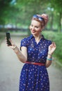 Beautiful woman in fifties style with braces taking picture of h Royalty Free Stock Photo