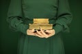Beautiful woman figure in dark green 50`s dress holding vintage book Royalty Free Stock Photo