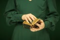 Beautiful woman figure in dark green 50`s dress holding vintage book Royalty Free Stock Photo