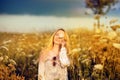 Beautiful woman in a flower meadow with sunglasses and flower, lust for life Royalty Free Stock Photo