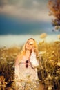 Beautiful woman in a flower meadow with sunglasses and flower, lust for life