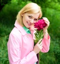 Beautiful woman with flower peony. Cute female in spring park. Smiling girl with pink flower in hand. Royalty Free Stock Photo