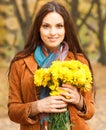 Beautiful woman with flowers in autumn park Royalty Free Stock Photo