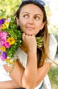 Beautiful woman with flowers daydreaming Royalty Free Stock Photo