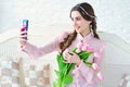 Beautiful woman with flowers shooting selfie Royalty Free Stock Photo