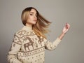 Beautiful Woman with flying hair in winter pullover. Beauty Blond Girl Royalty Free Stock Photo