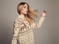 Beautiful Woman with flying hair in winter pullover. Beauty Blond Girl Royalty Free Stock Photo