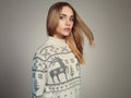 Beautiful Woman with flying hair in winter pullover. Beauty Blond Girl Royalty Free Stock Photo